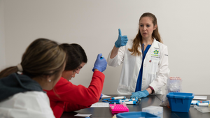 Amanda Hewes, MS, instructs students on how to use a micropipette during Learning Lab experience.