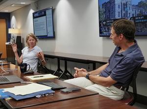 Cora Olson (at left) and Thomas Ewing discuss the ways the humanities and health sciences can work together during a workshop.