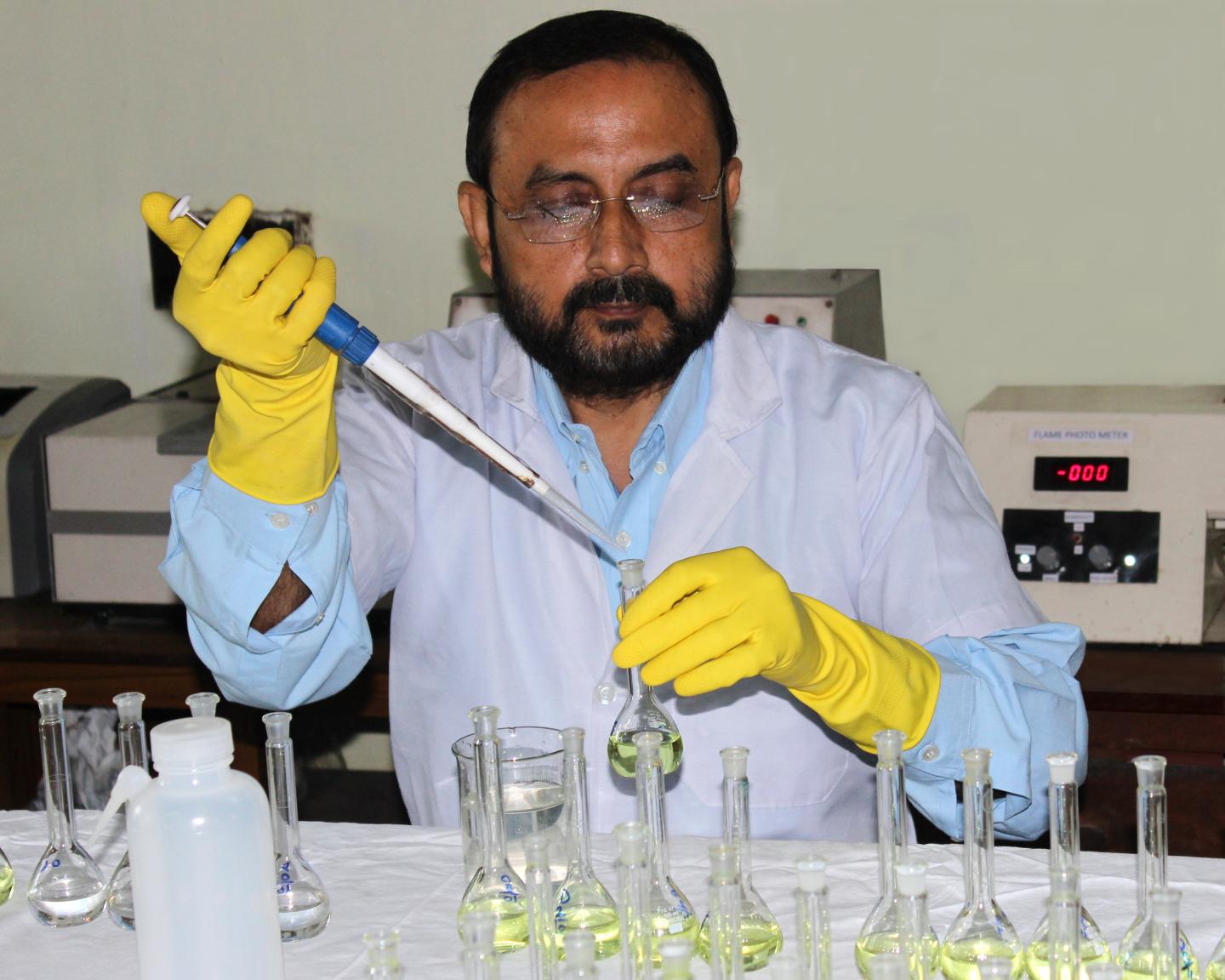 Researcher with Pipette and Flasks