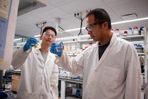 (From left) Graduate student Peidong Liu and mining and minerals engineering Associate Professor Wencai Zhang analyze water samples in the lab.