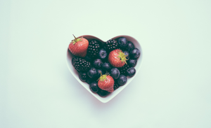 A heart-shaped bowl of fruit.