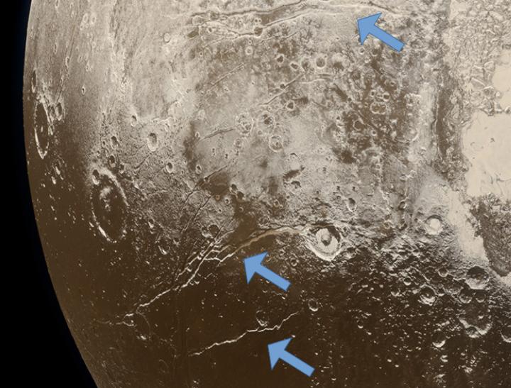 Extensional Faults on Pluto