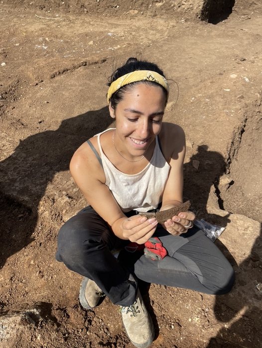 Claudia Paparella holds a yet to be dated fragment of glass