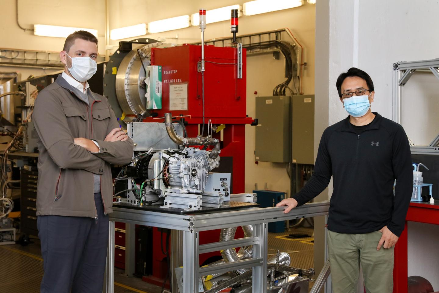 Researchers with prototype engine