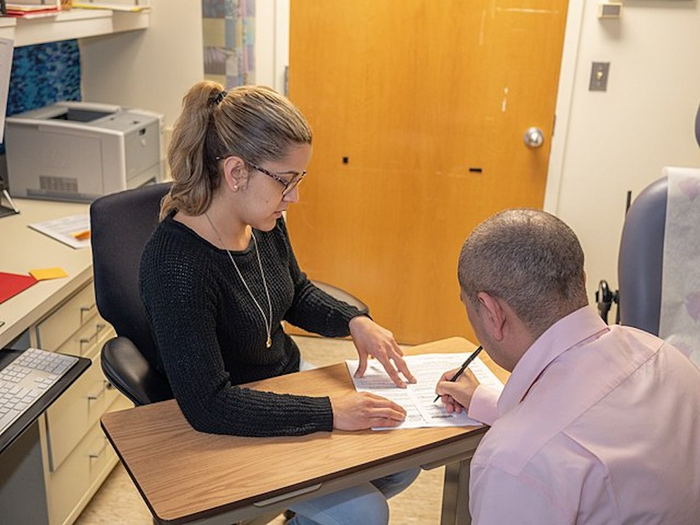 Clinical trial volunteer signs an informed consent form.