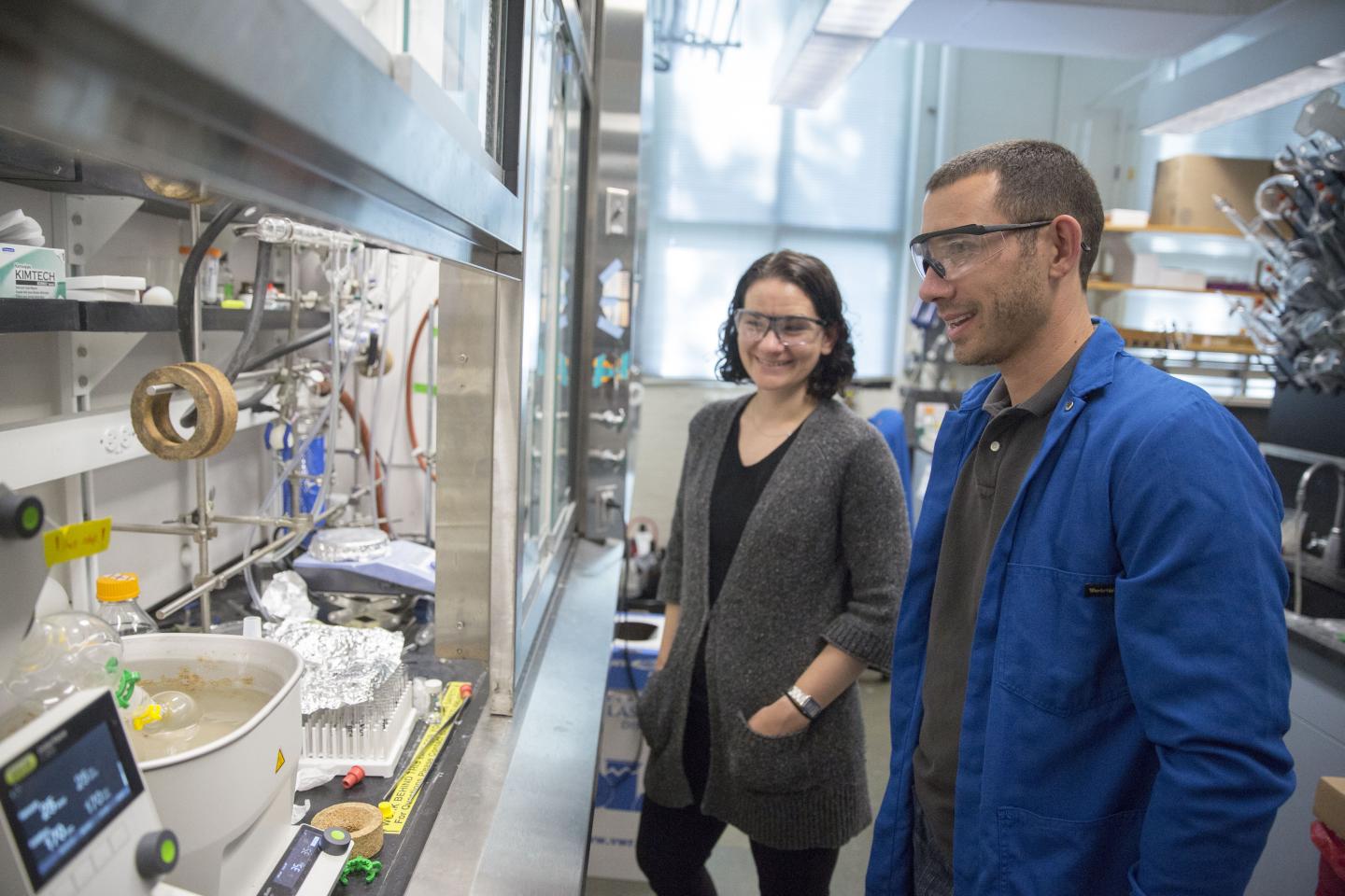 Emily Balskus Stands with a Postdoctoral Scholar in Her Lab