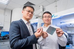 Professor Zhu Zonglong (left) and Dr Gao Danpeng of City University of Hong Kong hold their innovative solar cells.