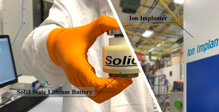 Researcher holding solid-state lithium-ion battery with Ion Implanter
