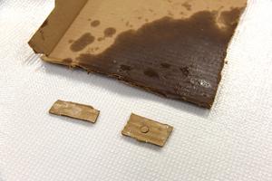 Successfully decontaminated pieces of cardboard, compared to the original