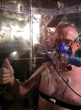 Participant seated within the calorimeter, which measures how much heat his body is losing.