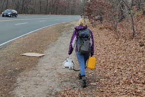 Sarah Garvey walks toward an urban research site in Newton, MA, LI-COR device in hand.