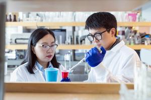 Dr. Tianxi Yang and student Peter Yang testing a cup for microplastics.