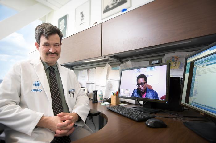 Andrew Talal, MD, in his office doing a telemedicine visit.