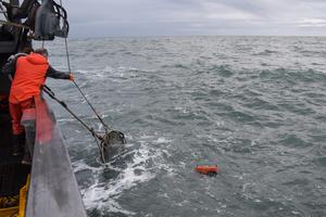 Researchers retrieve an instrument package from the Cook Inlet