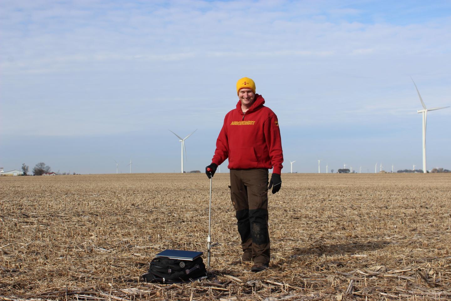Bradley Miller takes soil samples in the middle of an agricultural field.