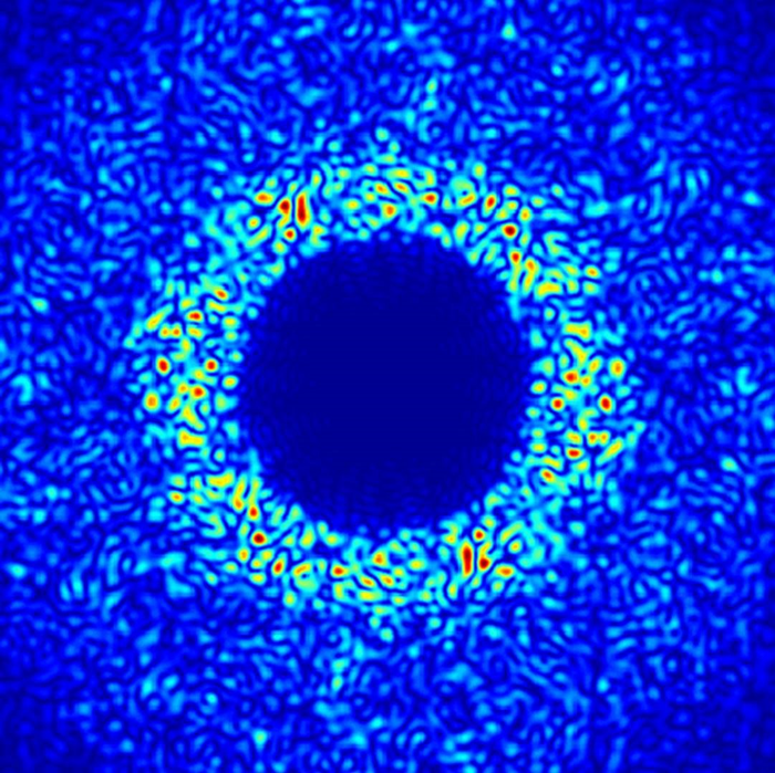 Light scattering from a thin silicon membrane absorbing 65% of sunlight