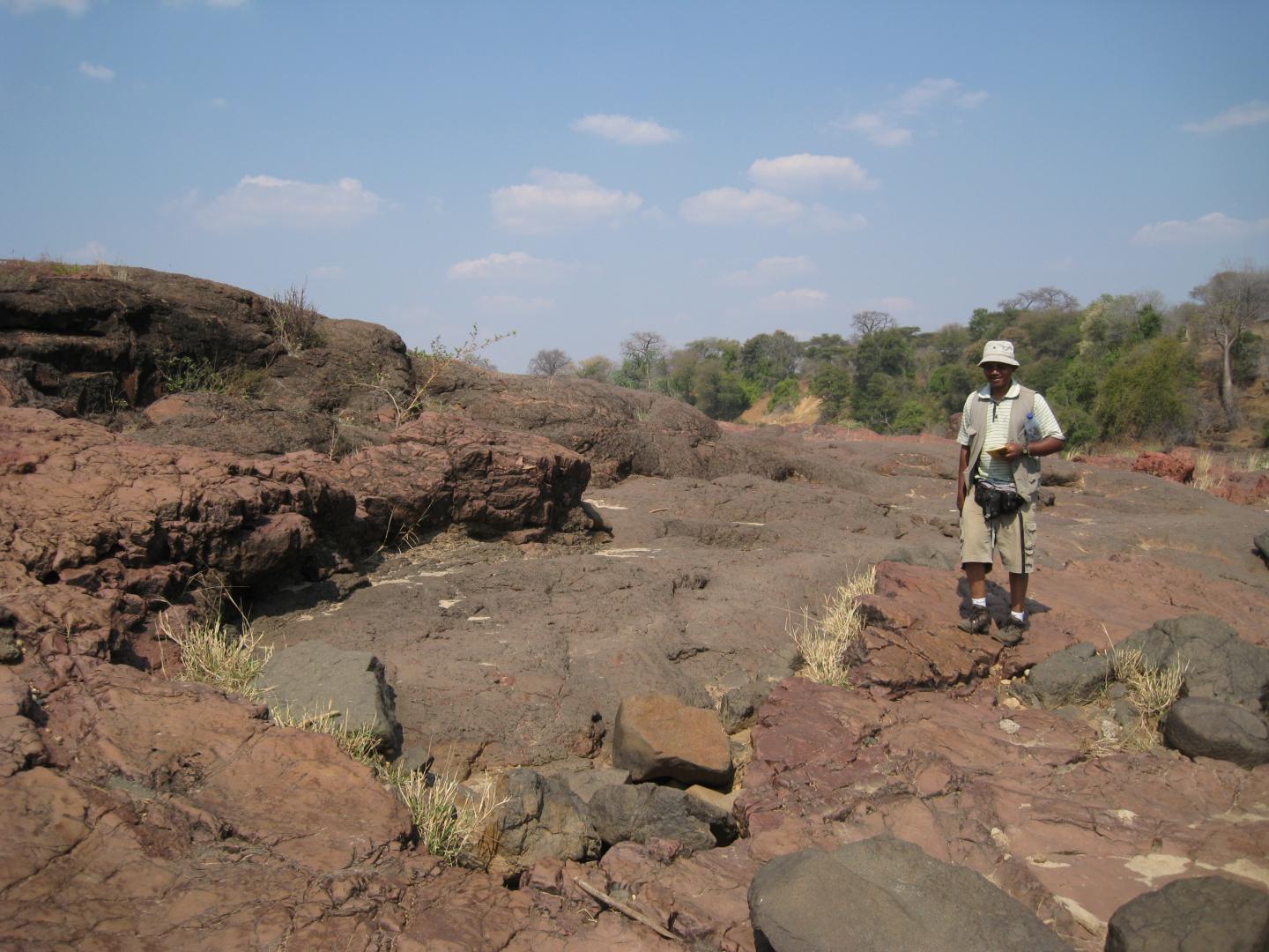 Professor Daúd Jamal Standing Next to Picrite Lava Outcrops on the Luenha River, Central Mozambique