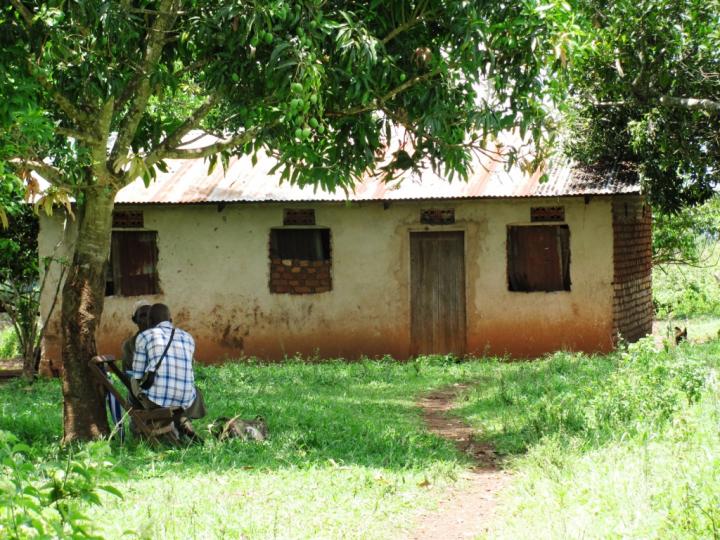 Innovations for Poverty Action Field Researcher talking with a Ugandan landowner