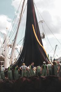 People Standing Beside the Fish Net