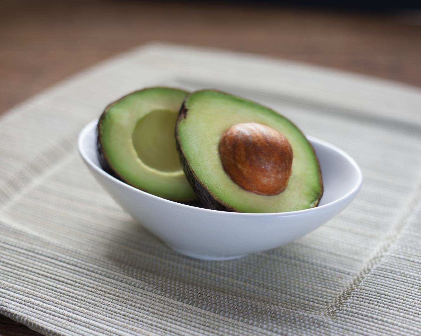 Halved Avocado in a White Bowl