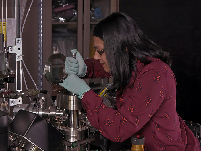 Sandra Taylor, a PNNL chemist, loads a sample into an atom probe tomography instrument.