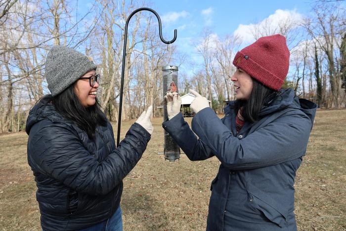 (From left) Sara Teemer and Dana Hawley at a bird feeder frequented by house finches.