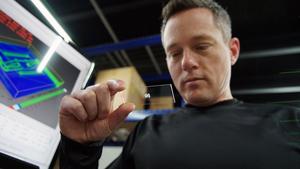 Jeff Schultz '03 inspects a 3D-printed organ on a chip at his lab in Charlotte.