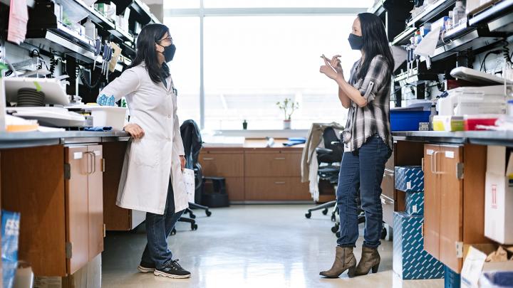 Gladstone scientists Nadia Roan (right) and Guorui Xie (left)