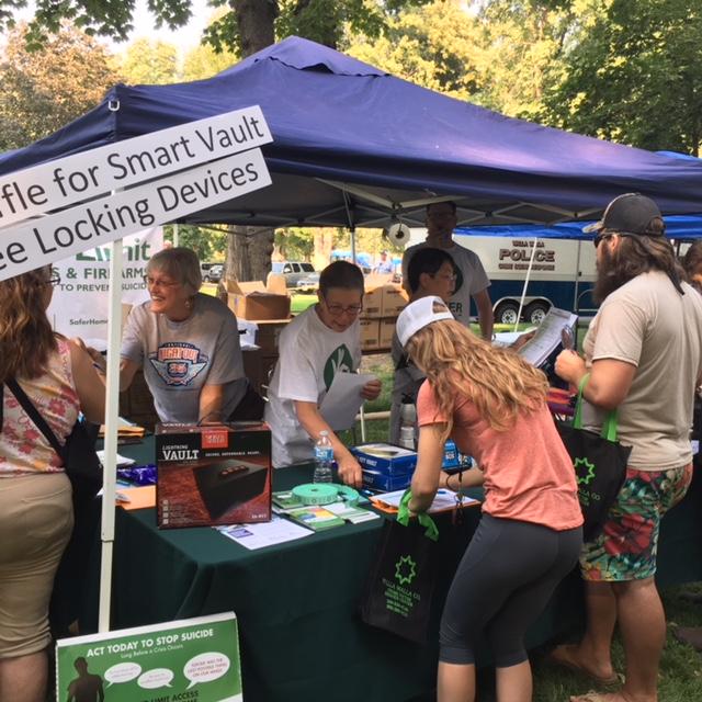 Volunteers talking about firearm safety, suicide prevention at community event