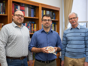 researchers pose with their compliant mechanism-enabled patch antenna prototype