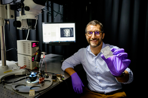 NTU Asst Prof Matteo Seita holding a piece of 3D-printed metal alloy