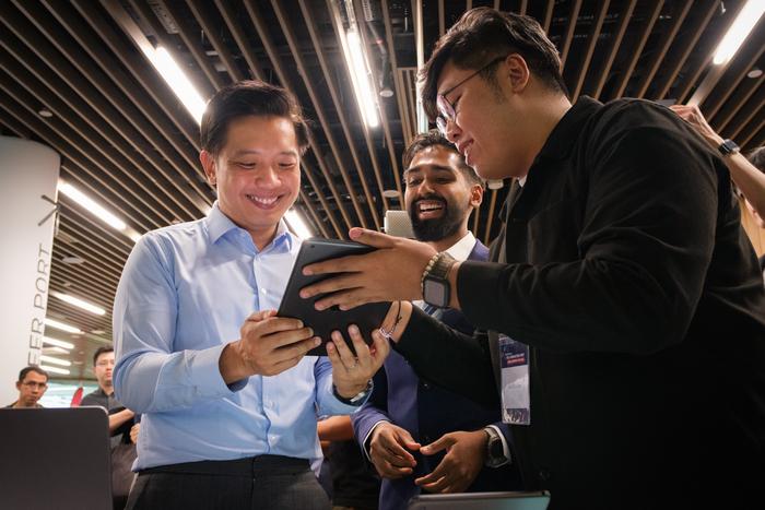 Minister of State Mr Alvin Tan (left) looking at ReCOGnAIze, a clinical game on a tablet that can help doctors detect the early onset of dementia in high-risk patients