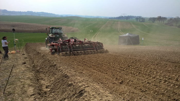 Soil tillage equipment moves large amount of material down slope as it is pulled through the soil
