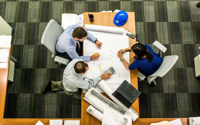 Three people working together.