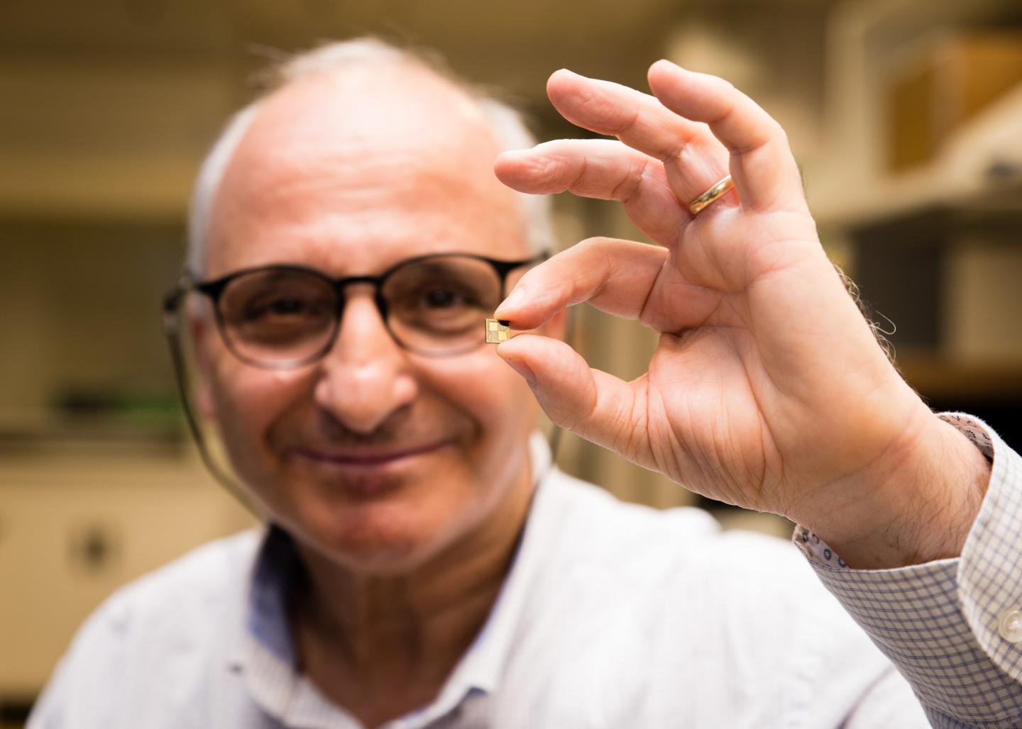 Rachid Yazami Holding His Small Smart Chip